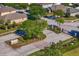 Street view of Sweetgrass entrance featuring landscaped median, decorative entry gate, and mature trees at 2935 Winglewood Cir, Lutz, FL 33558