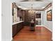 Elegant wine room with custom cabinetry, wine racks, and serving area with refrigerator at 2935 Winglewood Cir, Lutz, FL 33558