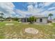 Expansive backyard with well-maintained lawn and tasteful landscaping elements surrounding the property at 301 Caloosa Palms Ct, Sun City Center, FL 33573