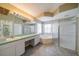 En-suite bathroom featuring a shower, soaking tub, double vanity, and tiled floor at 301 Caloosa Palms Ct, Sun City Center, FL 33573