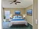 Cozy bedroom with a ceiling fan, bedside tables, and soft blue accents, creating a relaxing atmosphere at 301 Caloosa Palms Ct, Sun City Center, FL 33573