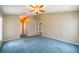 Large bedroom with light walls, blue carpet, and a ceiling fan at 301 Caloosa Palms Ct, Sun City Center, FL 33573