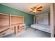 Bedroom boasting built in shelving units, a ceiling fan and a bed at 301 Caloosa Palms Ct, Sun City Center, FL 33573