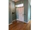 This entryway features hardwood floors, and a pendant light with natural light from a transom window at 301 Caloosa Palms Ct, Sun City Center, FL 33573