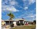 Inviting single-Gathering home boasting a lush front yard and colorful trim against a bright blue sky at 301 Caloosa Palms Ct, Sun City Center, FL 33573