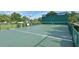 Outdoor handball court surrounded by green landscaping and fencing, perfect for recreational fun at 301 Caloosa Palms Ct, Sun City Center, FL 33573