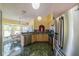 Bright kitchen with stainless steel appliances, natural wood cabinets, and an adjacent breakfast nook at 301 Caloosa Palms Ct, Sun City Center, FL 33573
