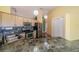 Bright kitchen with stainless steel appliances, wooden cabinets, and marble backsplash and floors at 301 Caloosa Palms Ct, Sun City Center, FL 33573