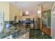 Bright kitchen with stainless steel appliances, wooden cabinets, and marble backsplash and floors at 301 Caloosa Palms Ct, Sun City Center, FL 33573