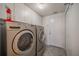 Laundry room equipped with front loading washer, dryer, and cabinetry at 301 Caloosa Palms Ct, Sun City Center, FL 33573