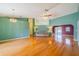 Open-concept living area featuring hardwood floors, soaring ceilings, and abundant natural light at 301 Caloosa Palms Ct, Sun City Center, FL 33573