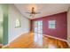Inviting living room with vaulted ceilings, hardwood floors, and sliding glass doors to the lanai at 301 Caloosa Palms Ct, Sun City Center, FL 33573