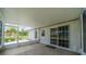 Covered screened porch with sliding glass doors at 301 Caloosa Palms Ct, Sun City Center, FL 33573