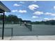 Community tennis court with shade and seating available, providing a social and recreational sports area at 301 Caloosa Palms Ct, Sun City Center, FL 33573