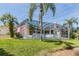 A spacious backyard with a screened-in pool, perfect for relaxing and entertaining amidst lush greenery at 3136 Sandhill Dr, Holiday, FL 34691