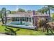 An aerial view of a backyard oasis, complete with a pool, patio, and lush landscaping, perfect for relaxation at 3136 Sandhill Dr, Holiday, FL 34691
