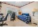 Comfortable bedroom with a desk, chair, and blue floral bedding at 3136 Sandhill Dr, Holiday, FL 34691