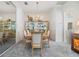Cozy dining room featuring a modern chandelier, display cabinet, and a comfortable seating arrangement at 3136 Sandhill Dr, Holiday, FL 34691