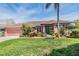 Beautiful single-Gathering home featuring a well-kept lawn, two-car garage, and inviting front entrance at 3136 Sandhill Dr, Holiday, FL 34691