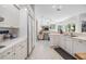 Open concept kitchen with bright white cabinets, stainless steel appliances, and seamless connection to the living area at 3136 Sandhill Dr, Holiday, FL 34691