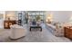 Bright living room with neutral tones, plush seating, and sliding glass doors to a patio at 3136 Sandhill Dr, Holiday, FL 34691
