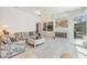 Spacious living area with tile floors, a fireplace, built-in shelving, and plenty of natural light at 3136 Sandhill Dr, Holiday, FL 34691