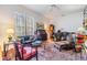 Bright living room features piano, sofa, vintage furniture, and large windows at 3136 Sandhill Dr, Holiday, FL 34691