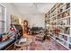 Eclectic living room with floor-to-ceiling bookshelf and unique decor at 3136 Sandhill Dr, Holiday, FL 34691