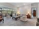 Cozy living room with neutral tones, plush seating, and sliding glass doors to a patio at 3136 Sandhill Dr, Holiday, FL 34691