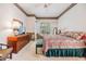 Comfortable main bedroom featuring patterned bedding, ceiling fan, and dresser at 3136 Sandhill Dr, Holiday, FL 34691