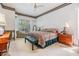 Comfortable main bedroom featuring patterned bedding, ceiling fan, and ample natural light at 3136 Sandhill Dr, Holiday, FL 34691