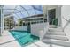 A refreshing screened-in pool with inviting blue tile accents, offering a perfect escape in the backyard at 3136 Sandhill Dr, Holiday, FL 34691