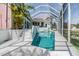 A spacious screened-in pool with crystal-clear water, complemented by lush greenery and a bright, sunny sky at 3136 Sandhill Dr, Holiday, FL 34691