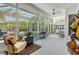 Inviting sunroom with tile flooring and access to outdoor pool area through large sliding glass doors at 3136 Sandhill Dr, Holiday, FL 34691