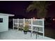 Backyard featuring white lattice fencing, tropical palm tree, and neutral groundcover with patio furniture at 3339 Avanti Cir, North Port, FL 34287