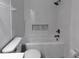 Well-lit bathroom showcasing a bathtub with shower, tiled walls, and modern fixtures at 3339 Avanti Cir, North Port, FL 34287