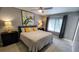Cozy bedroom featuring a ceiling fan, a queen-sized bed with new linens, and window at 3339 Avanti Cir, North Port, FL 34287