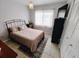 Cozy bedroom with tiled flooring, closet, and neutral decor at 3339 Avanti Cir, North Port, FL 34287