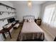 Cozy bedroom with natural light, desk, floating shelves, and a comfortable bed at 3339 Avanti Cir, North Port, FL 34287