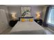 Bedroom with neutral tones featuring a queen-sized bed, ceiling fan, and a window at 3339 Avanti Cir, North Port, FL 34287