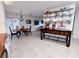 Open-concept dining area with a modern island and decorative dishware at 3339 Avanti Cir, North Port, FL 34287