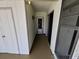 Clean hallway featuring a screen door and a light fixture at 3339 Avanti Cir, North Port, FL 34287