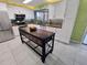 Spacious kitchen with white cabinetry, butcher block countertops, and a versatile kitchen island at 3339 Avanti Cir, North Port, FL 34287