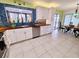 Contemporary kitchen featuring white cabinetry, butcher block countertops, and modern stainless appliances at 3339 Avanti Cir, North Port, FL 34287