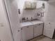 Functional laundry room featuring a washer, dryer, storage shelves, and ample space at 3339 Avanti Cir, North Port, FL 34287