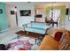 Bright living room with a comfortable sofa, rug, and open access to kitchen at 3339 Avanti Cir, North Port, FL 34287