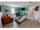 Bright living room featuring tile floors and comfortable seating arrangement at 3339 Avanti Cir, North Port, FL 34287