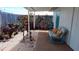 Cozy patio area featuring decorative plantings, seating, and neutral groundcover with a blue accent door at 3339 Avanti Cir, North Port, FL 34287
