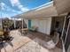 Inviting patio area with outdoor seating, lush plantings, neutral groundcover and a calming blue accent door at 3339 Avanti Cir, North Port, FL 34287