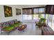 Relaxing sunroom with tile floors and large windows at 3339 Avanti Cir, North Port, FL 34287